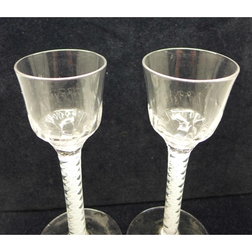 745 - A pair of 18th Century wine glasses, each with moulded ogee bowl over a double series open twist ste... 