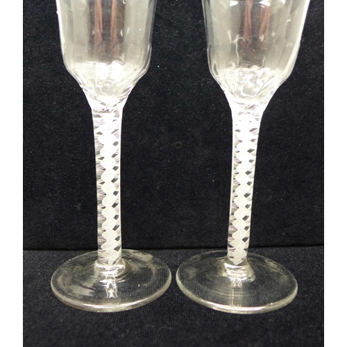 745 - A pair of 18th Century wine glasses, each with moulded ogee bowl over a double series open twist ste... 