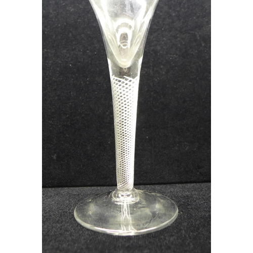 746 - An 18th Century wine glass with trumpet bowl over an air twist stem on a wide conical foot, 18cm