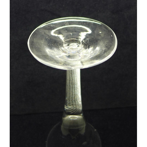 746 - An 18th Century wine glass with trumpet bowl over an air twist stem on a wide conical foot, 18cm