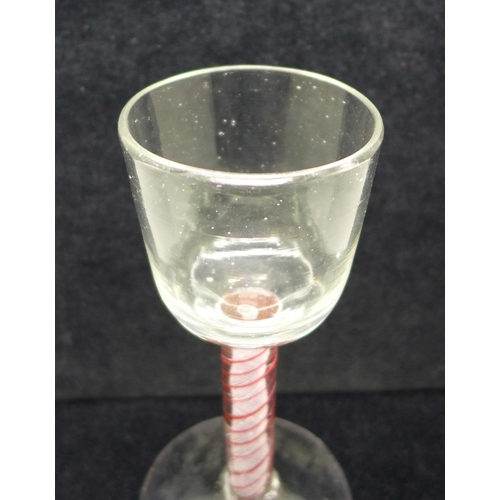 747 - An 18th Century colour twist wine glass, circa 1770, with a round funnel bowl over the stem containi... 