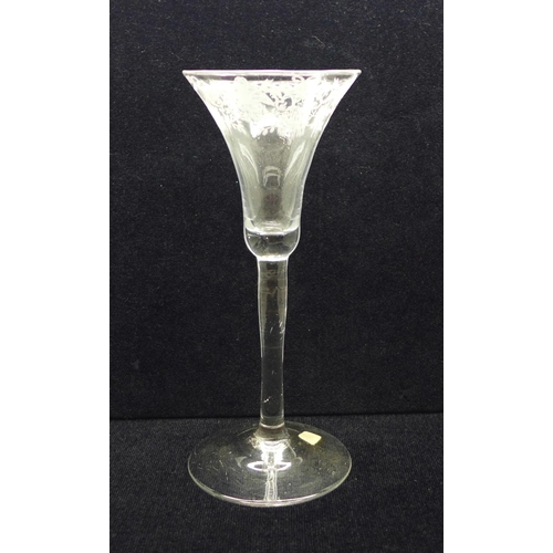 749 - A wine glass, circa 1730, engraved floral trumpet bowl over plain stem and wide conical foot, 17.5cm