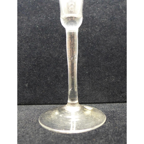 749 - A wine glass, circa 1730, engraved floral trumpet bowl over plain stem and wide conical foot, 17.5cm