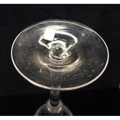 749 - A wine glass, circa 1730, engraved floral trumpet bowl over plain stem and wide conical foot, 17.5cm