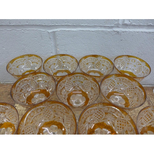 760 - A set of eleven champagne coupes each with engraved amber coloured bowl over a hexagonal faceted ste... 