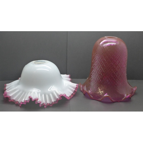 779 - A quilted cranberry glass shade and white glass shade with applied cranberry frill