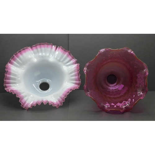 779 - A quilted cranberry glass shade and white glass shade with applied cranberry frill