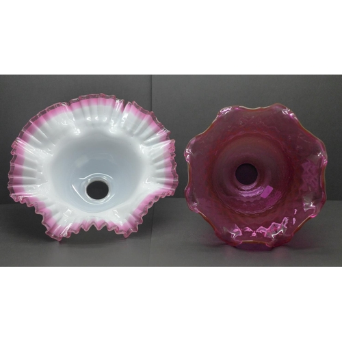 779 - A quilted cranberry glass shade and white glass shade with applied cranberry frill