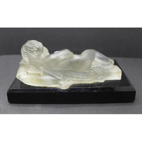 785 - A paperweight with a frosted glass model of a sleeping child on a rectangular black glass base