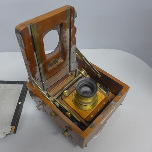 828 - A small mahogany land camera, a/f and a book on antique cameras