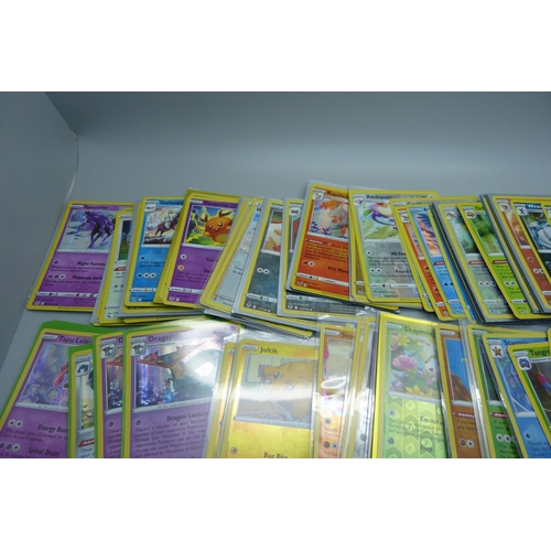 878 - 125 Holo and reverse holo Pokemon cards in protective sleeves including black star rares