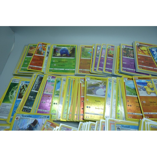 882 - 125 Holo and reverse holo Pokemon cards in protective sleeves including black star rares