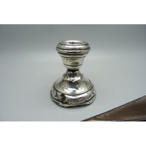 895B - A small silver candlestick, a/f, and a silver handled shoehorn, a/f