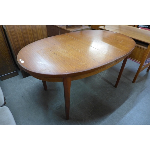 127 - A teak extending dining table