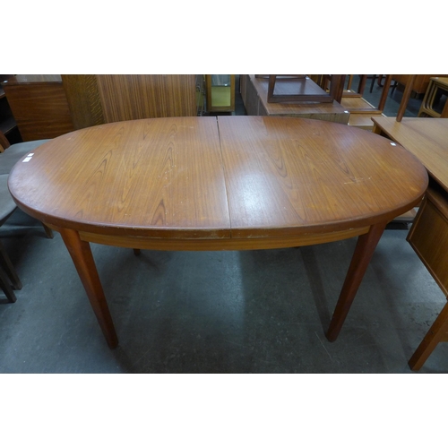 127 - A teak extending dining table