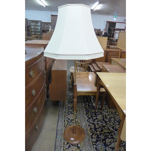 140 - A teak and brass standard lamp