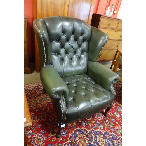 168 - A green leather Chesterfield wingback armchair