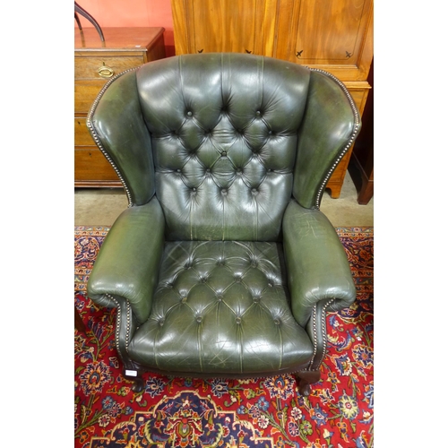 168 - A green leather Chesterfield wingback armchair