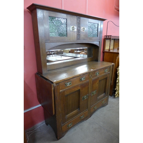 174 - An Arts and Crafts oak mirrorback sideboard