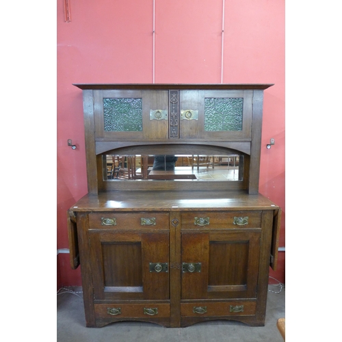 174 - An Arts and Crafts oak mirrorback sideboard