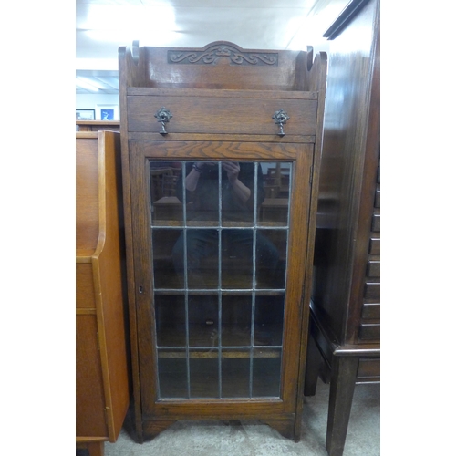 191 - An early 20th Century carved oak single door bookcase