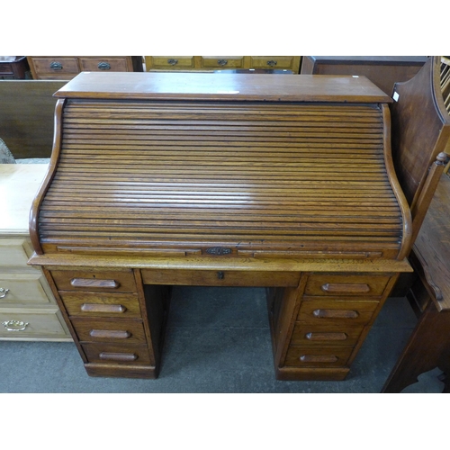 202 - An early 20th Century oak tambour roll top desk