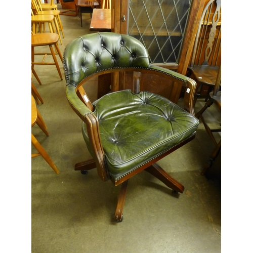 213 - A beech and green leather revolving Captain's desk chair