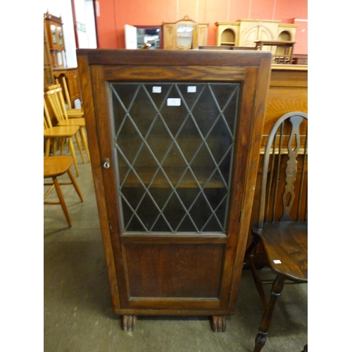 216 - An Art Deco oak single door bookcase