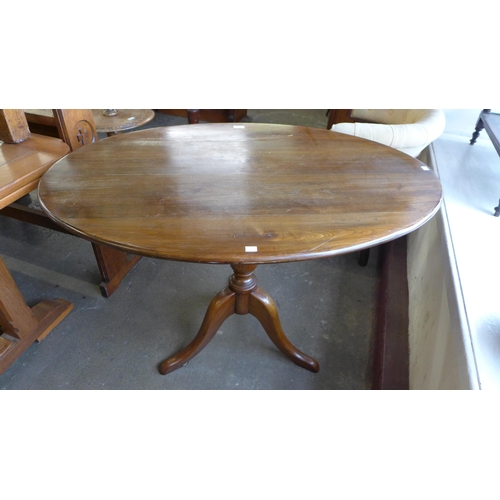 261 - A beech oval tripod loo table