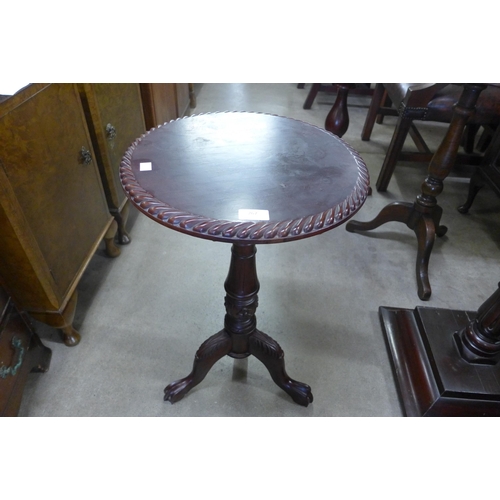 267 - A Chippendale style carved mahogany circular tilt top tripod wine table