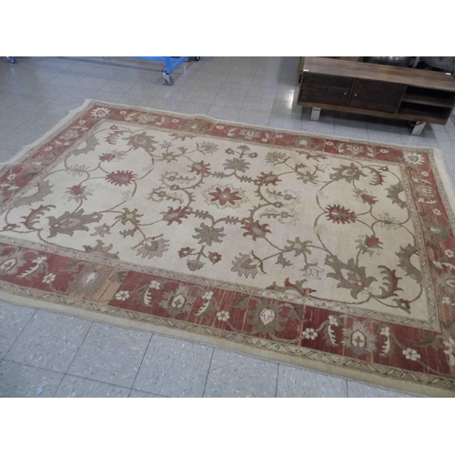 354 - A large eastern beige ground rug