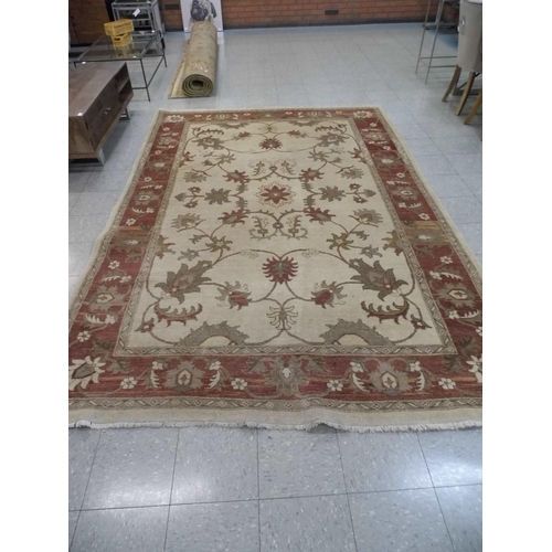 354 - A large eastern beige ground rug