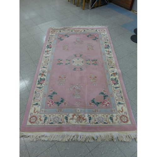 355 - A Chinese pink ground rug