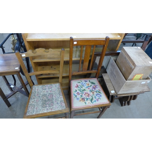 360 - A light oak bookcase, two chairs, an oak nest of tables, two wooden boxes, etc.