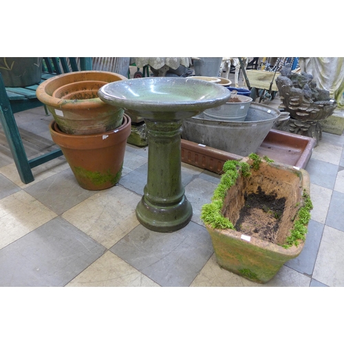 383 - Six terracotta plant pots and a small green glazed terracotta bird bath