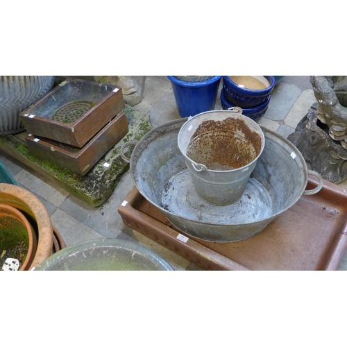 384 - A Victorian saltglazed sink, a reconstituted stone sink, a pair of grates, a galvanised bucket and t... 