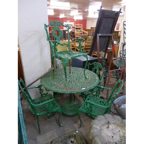 388 - A green cast alloy garden table and four chairs