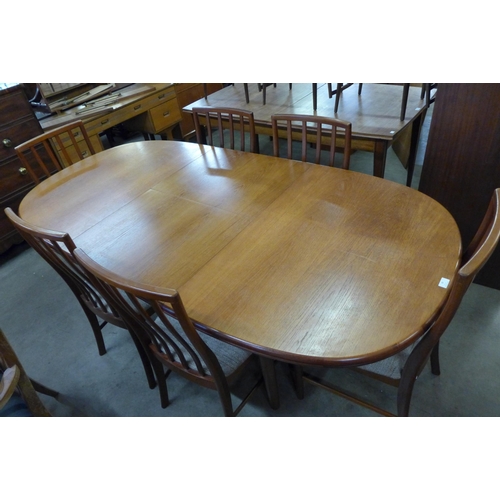 39 - A McIntosh teak extending dining table and eight chairs