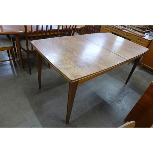 40 - A teak extending dining table