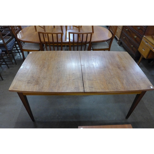 40 - A teak extending dining table