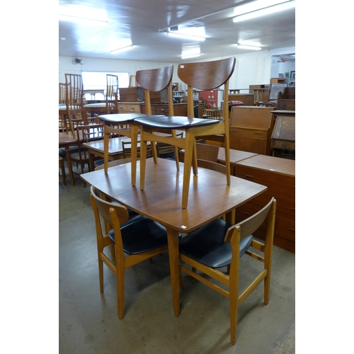 42 - A teak extending dining table and six chairs