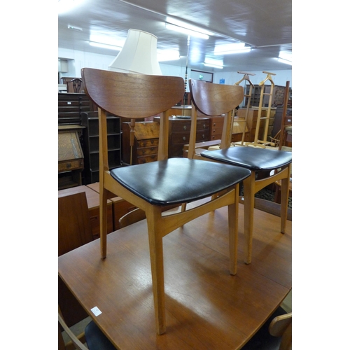 42 - A teak extending dining table and six chairs