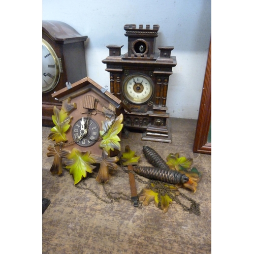 504A - A late 19th Century German oak architectural cased cuckoo mantel clock and a wall mounted cuckoo clo... 