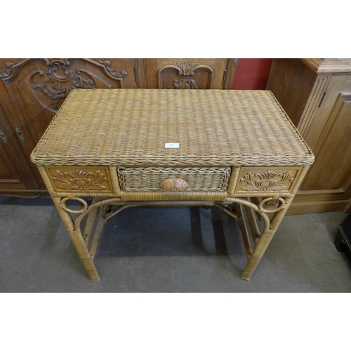 77 - A beech and wicker single drawer desk