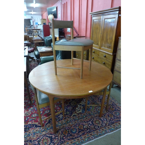 8 - A McIntosh teak circular extending dining table and four chairs