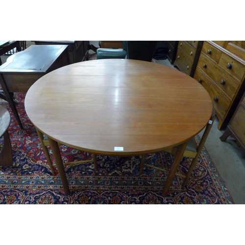 8 - A McIntosh teak circular extending dining table and four chairs