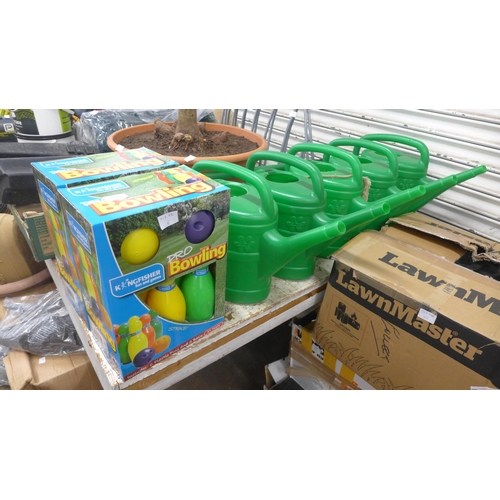 2335 - Five Watering cans, two garden bowling sets and a set of lawn edging sheers