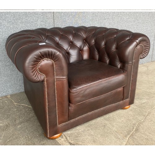 212 - A brown leather Chesterfield club chair