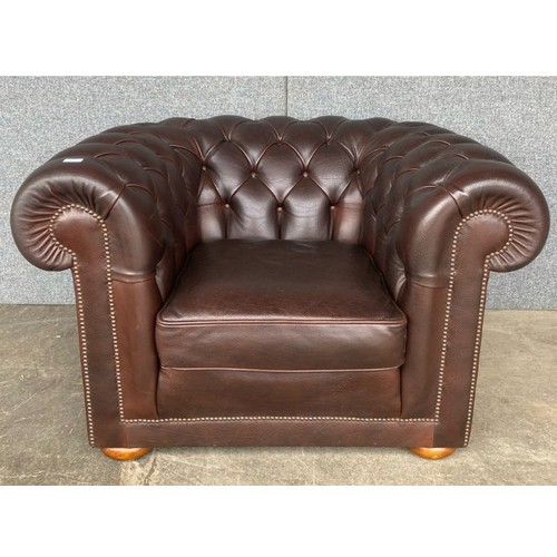 212 - A brown leather Chesterfield club chair