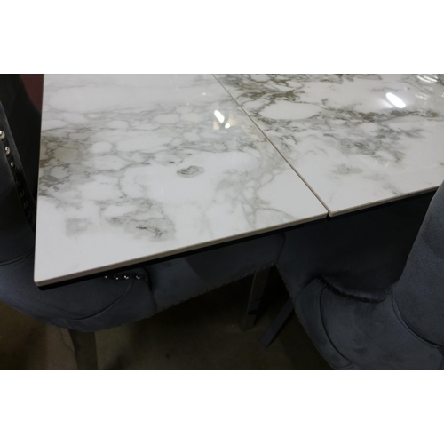 1362 - A Kos marble effect extending dining table with a set of six Marvel grey button back and studded din... 